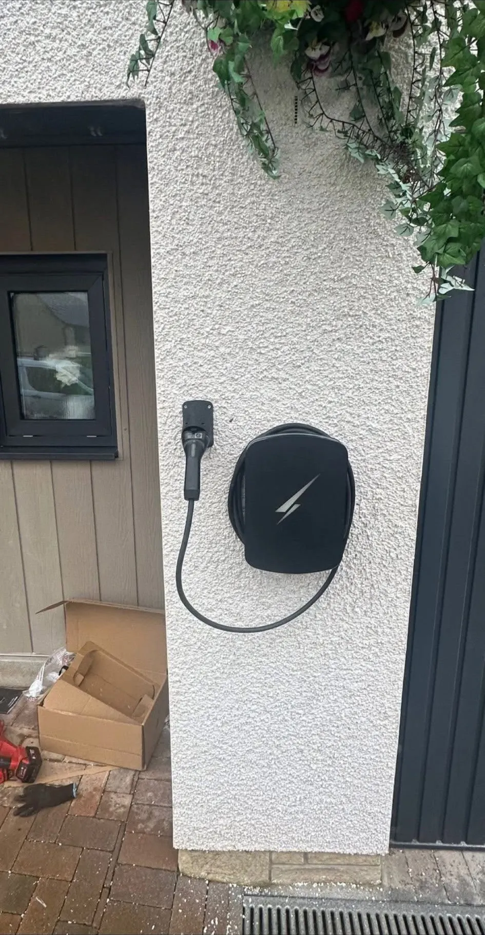 EV charge point installation on a rendered house wall