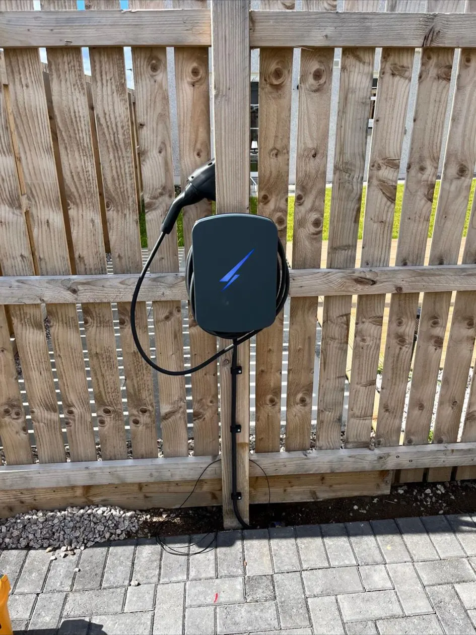 EV charger mounted on a timber fence