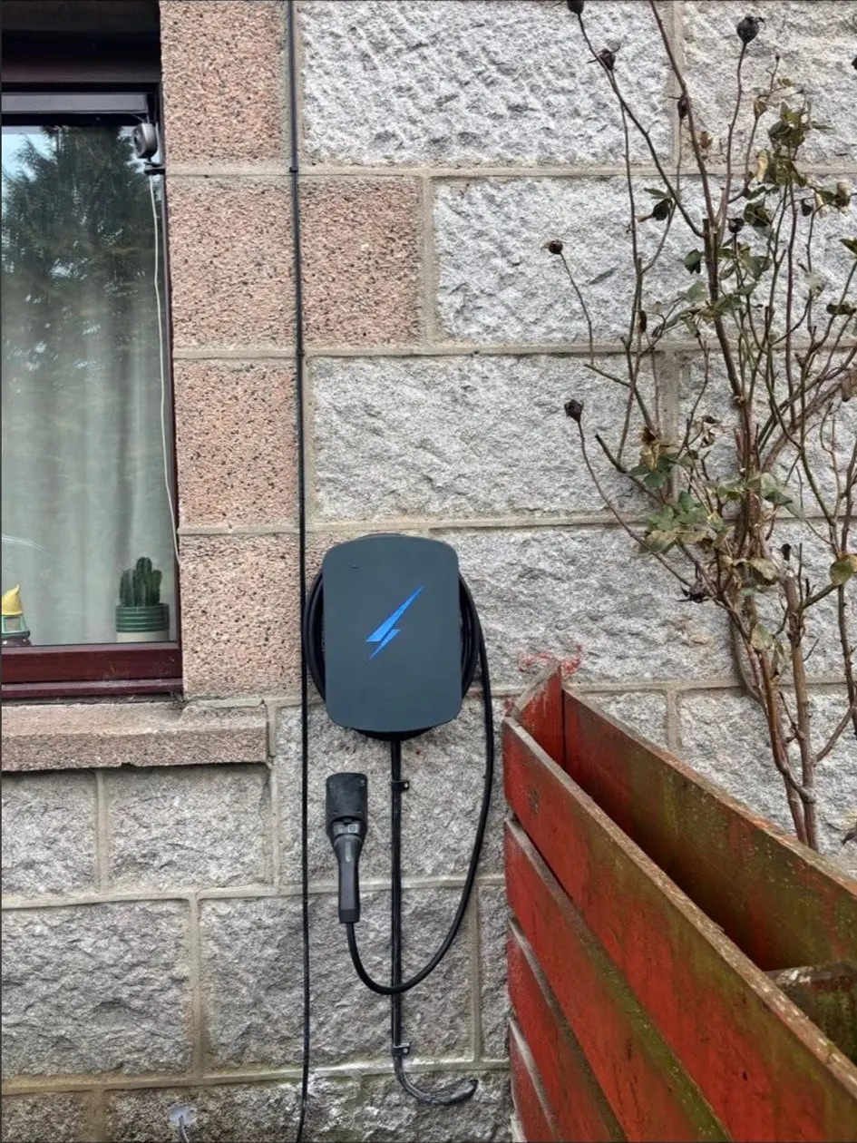 EV charge point on a stone cottage wall