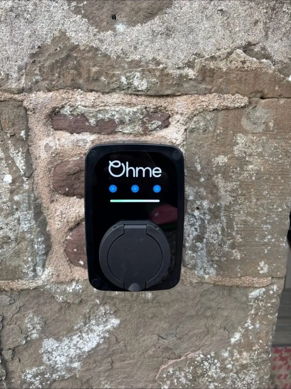 Ohme untethered charge point on weathered sandstone